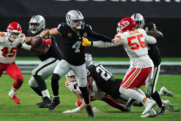 Nov 22, 2020; Paradise, Nevada, USA; Las Vegas Raiders quarterback Derek Carr (4) moves the ball against Kansas City Chiefs defensive end Frank Clark (55) during the first half at Allegiant Stadium. Mandatory Credit: Kirby Lee-USA TODAY Sports